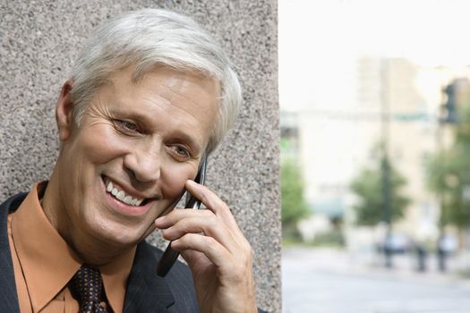 Caucasian middle aged businessman talking on phone.