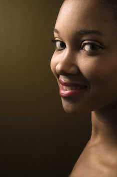 Smiling African-American young adult female looking at viewer.