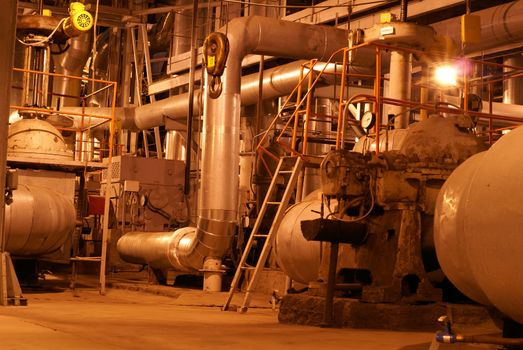 an assortment of different size and shaped pipes at a power plant    