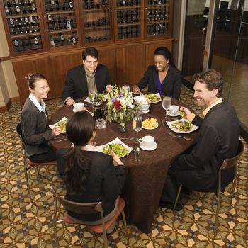 High angle of group of businesspeople in restaurant dining.