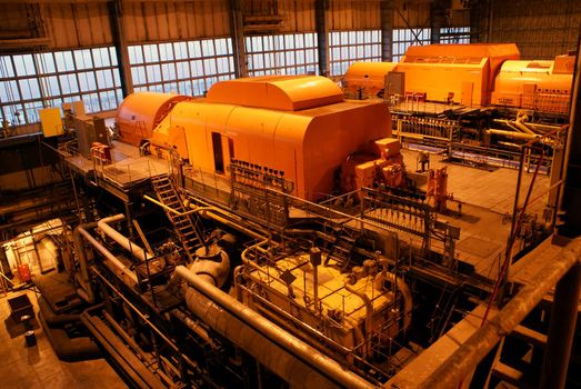 steam turbine and different size and shaped pipes at a power plant           