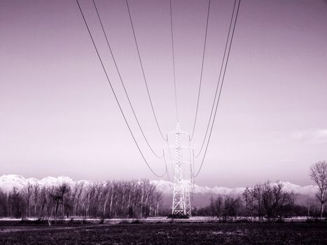 Electric transmission line towers in natural landscape