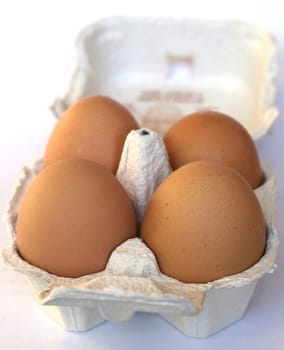 Four eggs in a cardboard wrap box