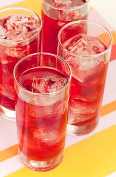 Chilled red beverage with ices on the tall glass