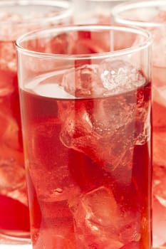 Chilled red beverage with ices on the tall glass