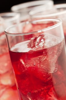 Chilled red beverage with ices on the tall glass