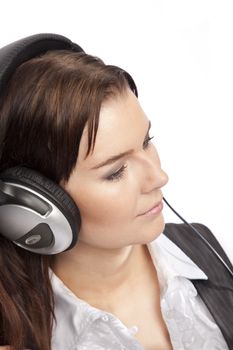 isolated young business woman listening music over white background