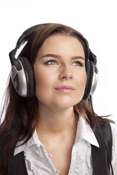 isolated young business woman listening music over white background