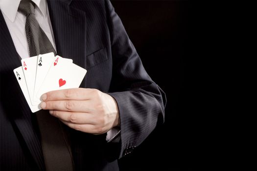 Man showing winning hand with four aces