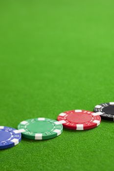 Blank casino chips on the green gaming table