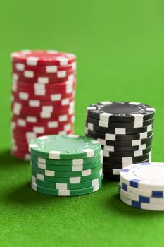 Blank casino chips on the green gaming table