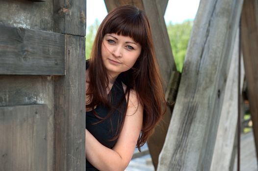 Young, beautiful woman looks at the camera from old-time watch box.
