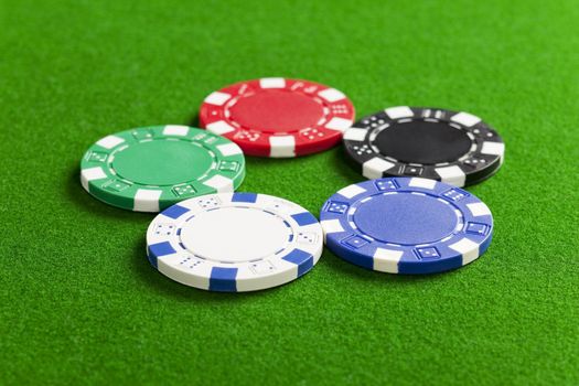 Blank casino chips on the green gaming table