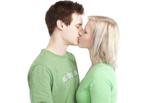 isolated cute young couple in love over white background wearing green shirts