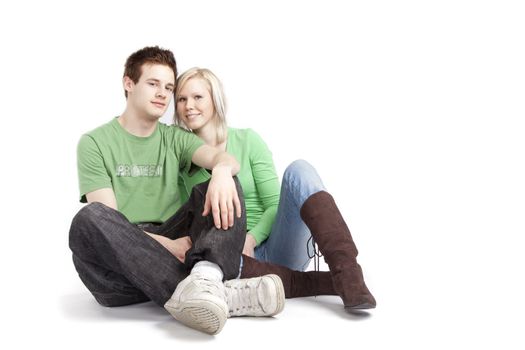 isolated cute young couple in love over white background wearing green shirts