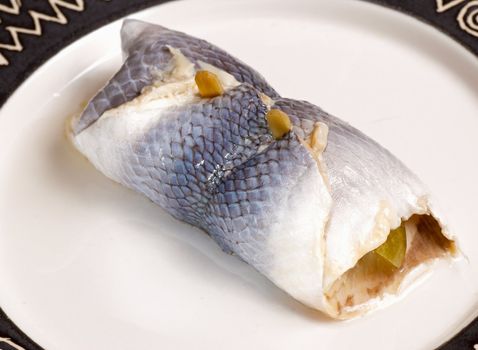 A fresh, pickled rollmops hering on a plate