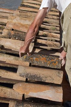 Construction worker interlocking spanish roof tiles