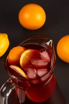 High angle view of a sangria pitcher surrounded by fruit