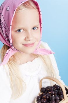 Young country girl with basket filled with berries