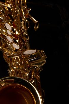 Frontal detail view of a golden alto saxophone
