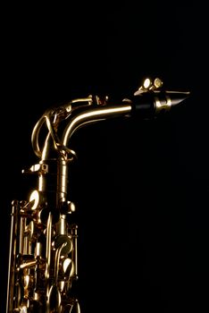 Upper third of an alto saxophone, copy space available