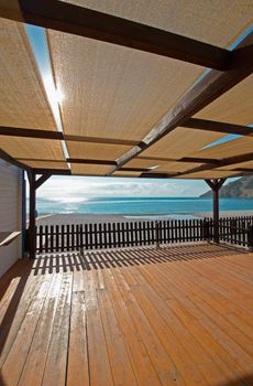 Scenic terrace overlooking a sunny Mediterranean beach