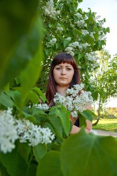 Portrait of young beautiful woman with pipe-tree.
