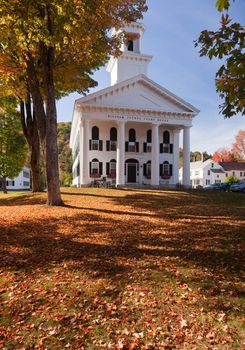 Autumnal shot of the Windham County Court House in fall as the bright trees turn orange and red