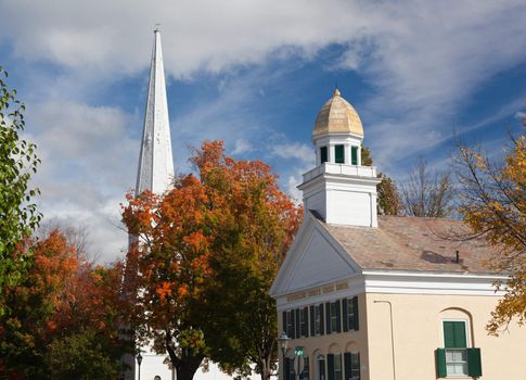 Autumnal shot of the main street of Manchester Vermont in fall as the bright trees turn orange and red