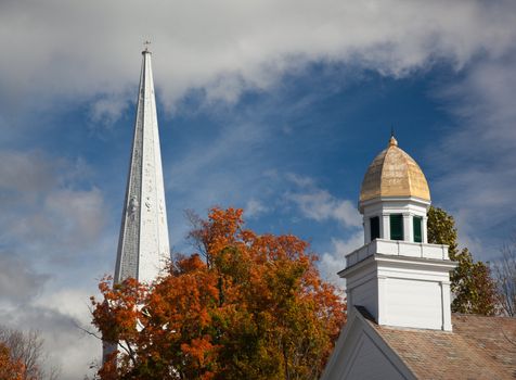 Autumnal shot of the main street of Manchester Vermont in fall as the bright trees turn orange and red