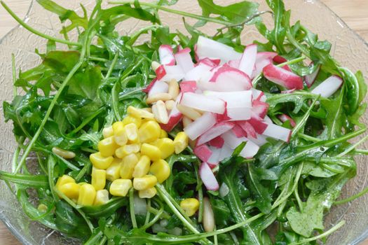 Closeup of rocket salad with radish and corn