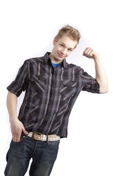 Isolated teen boy posing and pointing finger over white background