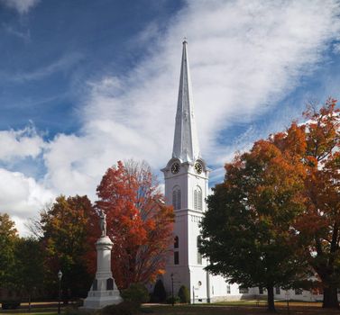 Autumnal shot of the main street of Manchester Vermont in fall as the bright trees turn orange and red