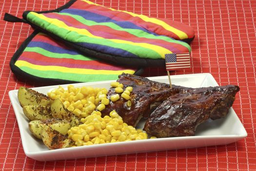 Grilled spare ribs with potatoes and corn