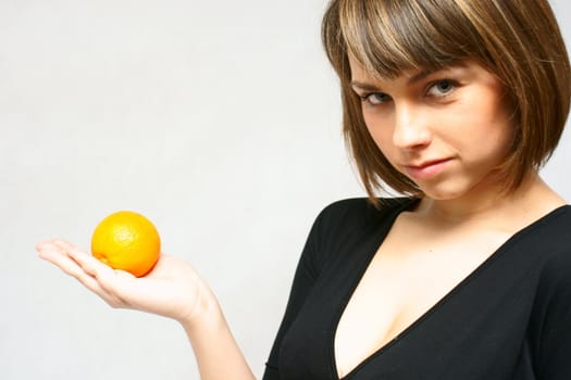 young girl with orange fruit in isolated white background