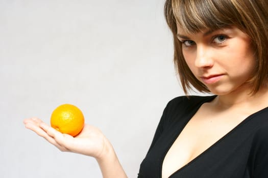 young girl with orange fruit in isolated white background