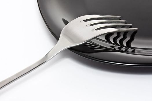 Black high-gloss plate with stainless fork