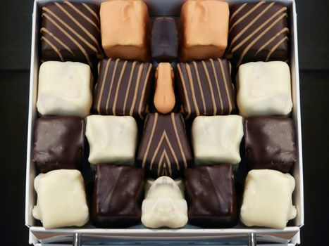 Delicious background of dark, milk, and white chocolate pralines.