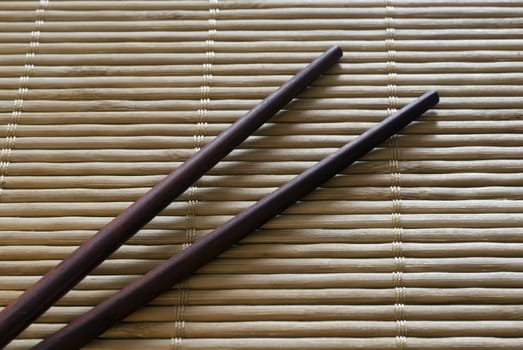 Chopsticks on a bamboo roll placemat