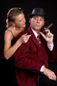 Woman lighting cigar for man