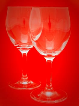 two wineglasses over the red background