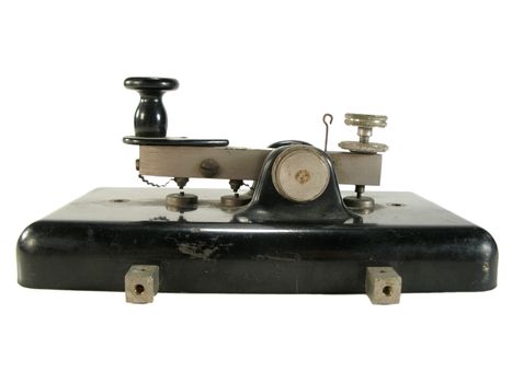 Original old morse key isolated on white.