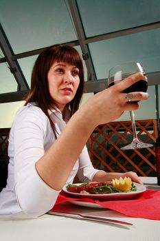 Young woman having some wine before dinner.