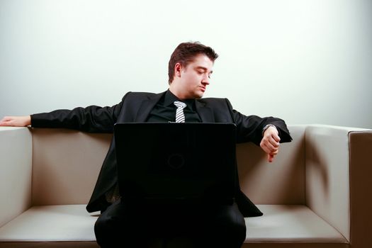 Businessman on lounge holding a laptop