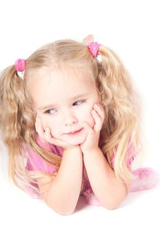 Little cute girl in pink and with ponytails in studio