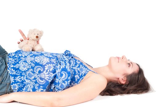 Portrait of pretty pregnant woman with toy bear isolated on white