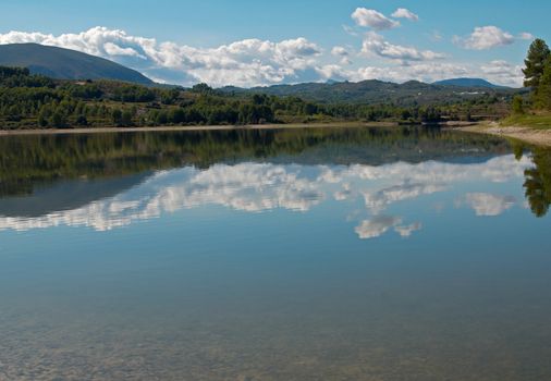 Peaceful lake landscape, the sky reflecting on its surface