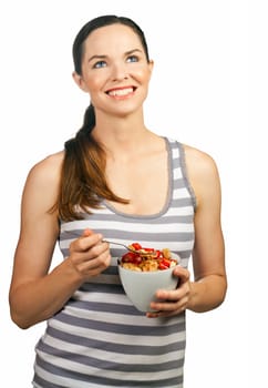 Portrait of a beautiful young woman smiling and holding a healthy bowl of cereal with strawberries. Isolated over white. 