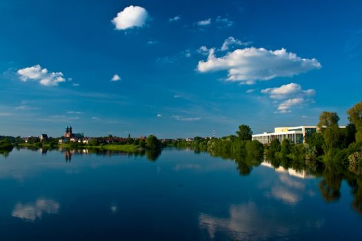 Sunny landscape at the river with clouds
