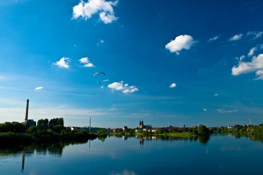 Sunny landscape at the river with clouds
